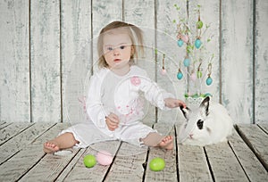 Girl with Down Syndrome holding the ear easter bunny