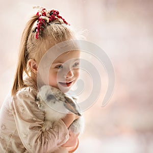 Girl with Down syndrome hugs rabbit