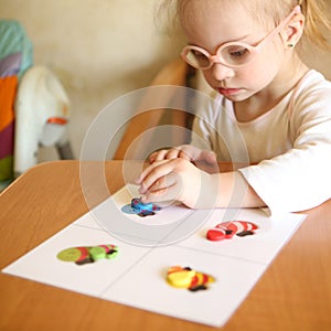 Girl with Down syndrome is involved in sorting