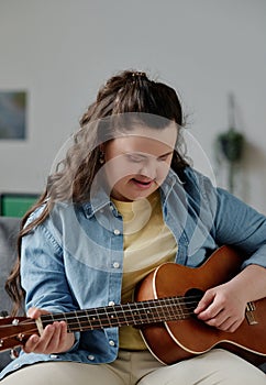 Girl with down syndrome learning to play guitar