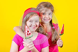 Girl Down syndrome and little girl with large Lollipop