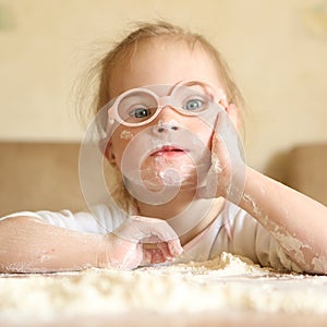 Girl with Down syndrome playing flour