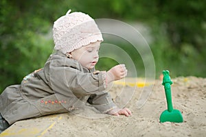 Girl with Down syndrome playing in the sandbox