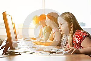Girl with Down syndrome using computer at school photo