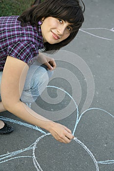 Girl drawing on asphalt