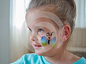 Girl with drawing butterflies on face