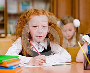 Girl drawing in copybook in classroom