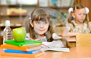 Girl drawing in copybook in classroom photo