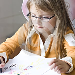 Girl drawing at home