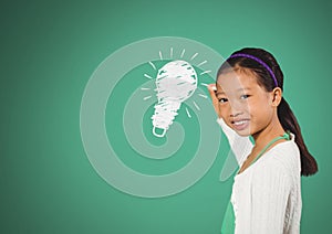 Girl drawing light bulb in front of green blank background with nature graphics