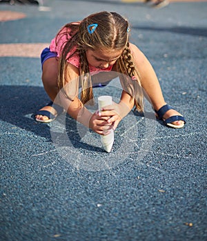 Girl Drawing Sun on Ground