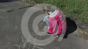 Girl Drawing sun and happy summer on asphalt