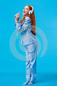 Girl dreaming become star. Vertical full-length portrait charming and carefree redhead teenager in nightwear, donwload