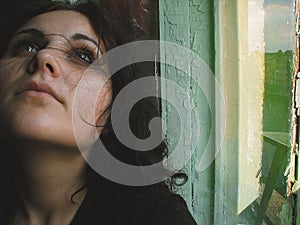 Girl dreaming by the window