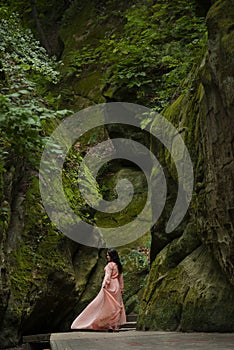 Girl in a dress on a background of stones