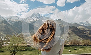 Girl dress behind summer looks mountains snow peaks