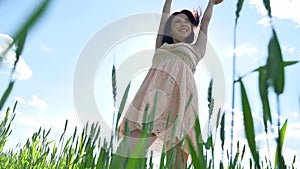 Girl in a dress in a field of green grass. Girl sunlight glare lifestyle sun, summer happiness