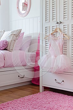 Girl dress hanging on wardrobe in bedroom