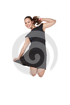 Girl in a dress jumping in studio