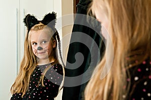 Girl dressed as kitten seeing herself