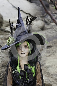 Girl dressed as witch holding black roses