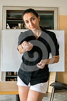 Girl dressed in black and white in front of a white board / teacher handling a pen