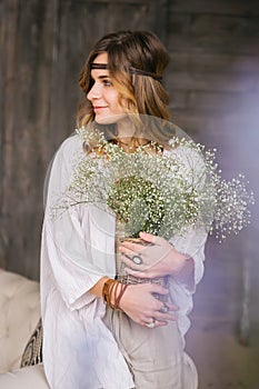 Girl dressed with large bouquets of white flowers