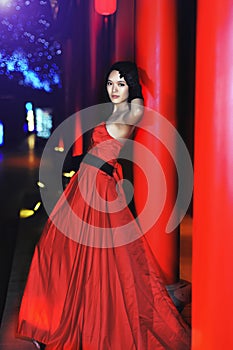 A girl dressed in a red evening dress photo