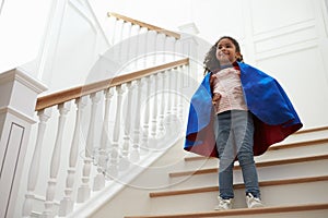 Girl Dressed Up As Superhero Playing Game On Stairs