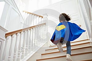 Girl Dressed Up As Superhero Playing Game On Stairs