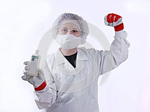 Girl in a dressing gown and mask with a disinfectant