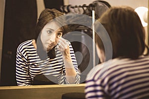 The girl in the dressing room is getting ready for the performan