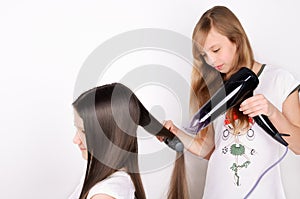 Girl dries hair the hair dryer photo