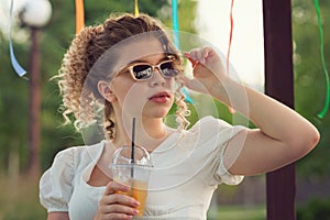 Girl with drink outdoors