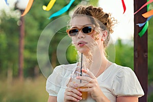 Girl with drink outdoors