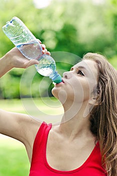 Girl drink water in park