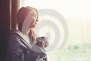 Girl drinking coffee or tea in morning