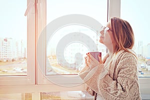 Girl drinking coffee or tea in morning