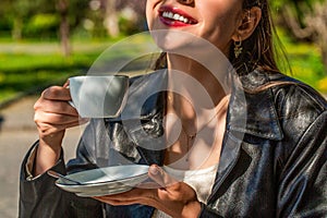 Girl drinking coffee. Woman holding cup hot coffees in hands. Girl drinking coffee. White mug hot coffee in the hands