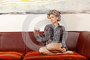 girl drinking a drink on the couch