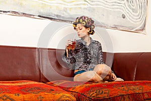 girl drinking a drink on the couch