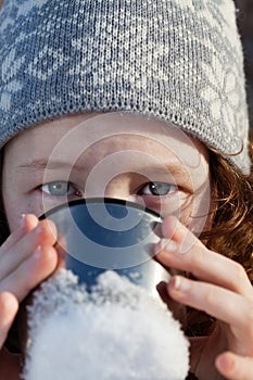 Girl drinking from flask cup