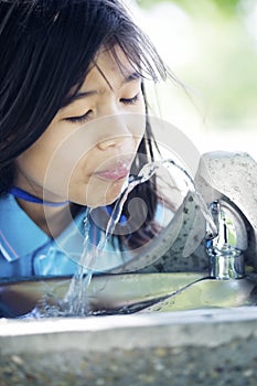 Girl drinking from fountain