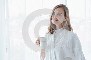 girl drinking hot coffee or tea in morning