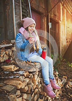 Girl drinking hot tea from the thermos
