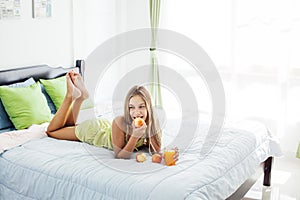 Girl drinking juice and relaxing in bedroom