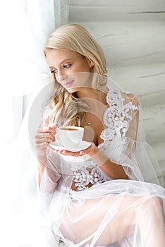 Girl drinking morning tea in the bedroom
