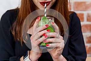 Girl drinking spinach, avocado and mint smoothie