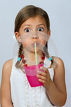 Girl drinking through a straw