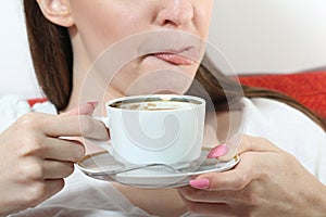 Girl drinking tea and lick one& x27;s lips